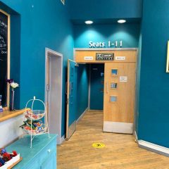 Auditorium entrance for seat numbers 1-11, next to the café bar